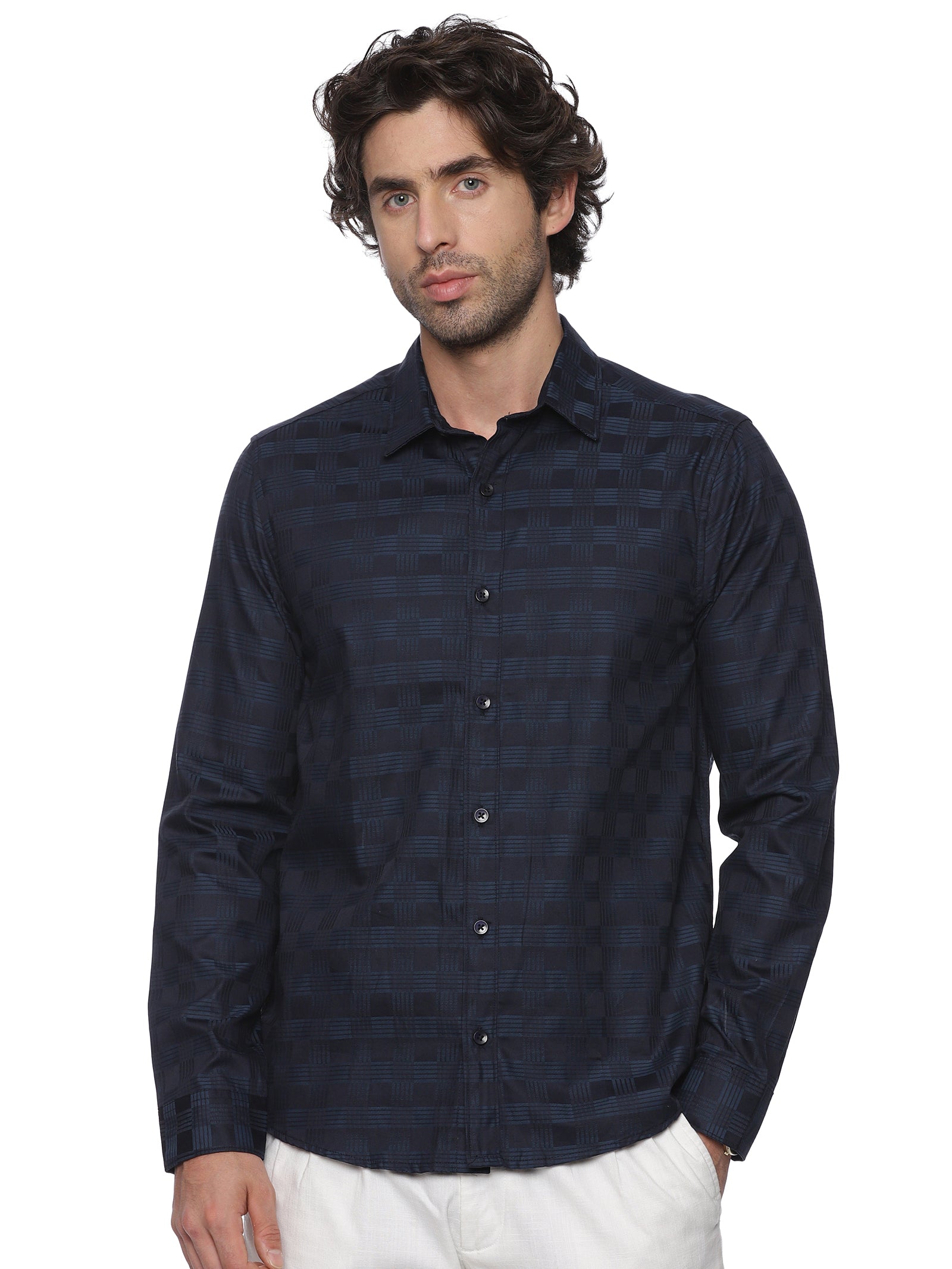 Man wearing a dark blue checkered shirt on a white background