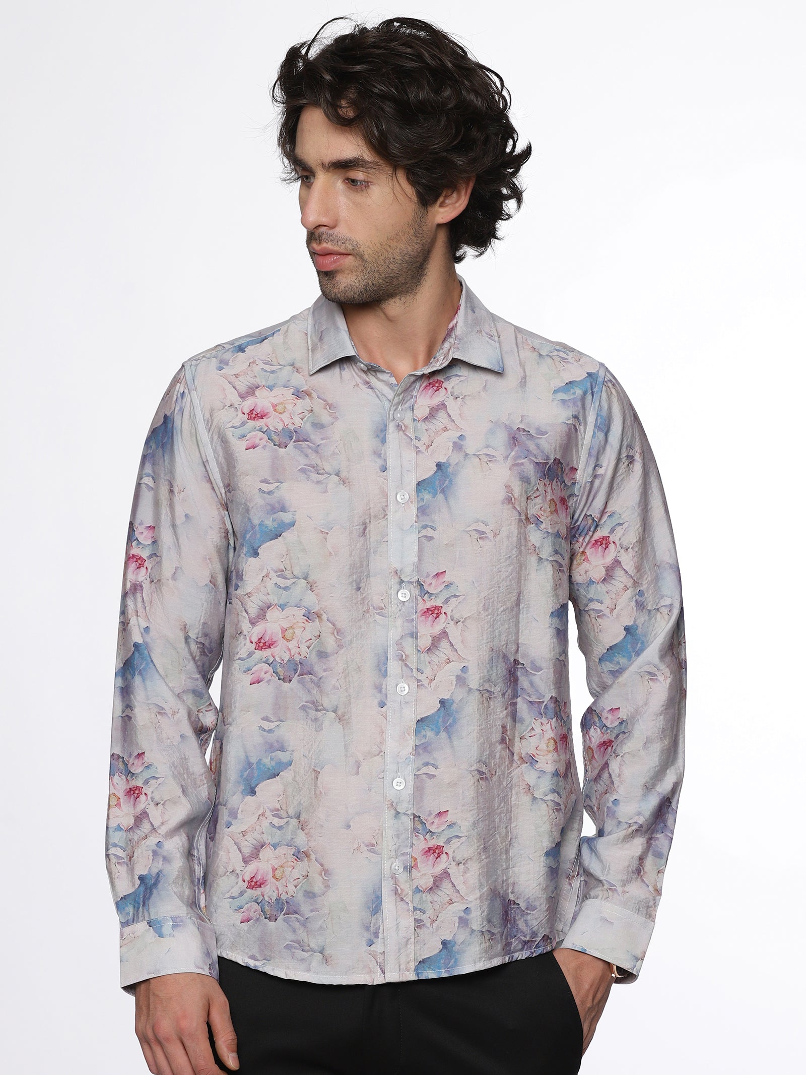 Man wearing a floral patterned shirt on a white background